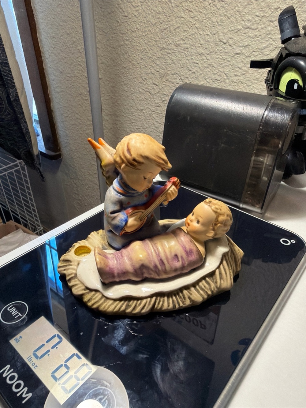 Hand-Painted Porcelain Angel Figurine with Baby is missing small pots on right s